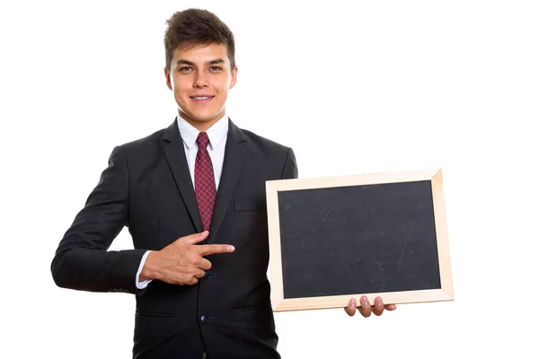 Young happy businessman smiling while holding blank blackboard a — Stock Photo, Image