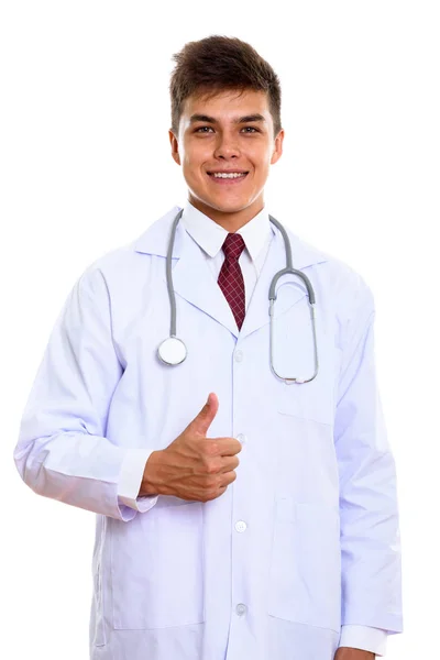 Studio shot of young happy man doctor smiling while giving thumb — Stock Photo, Image