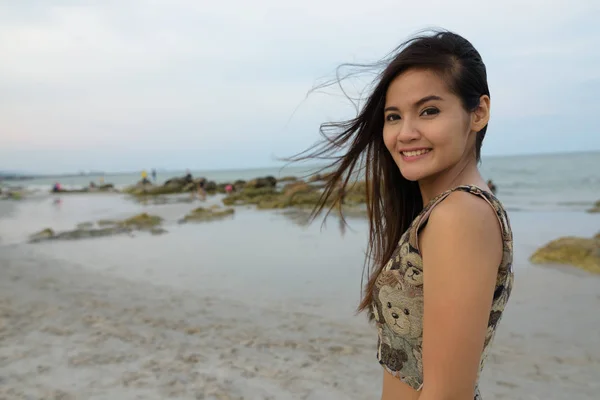 Young happy beautiful Asian woman smiling at the public beach of — Stock Photo, Image