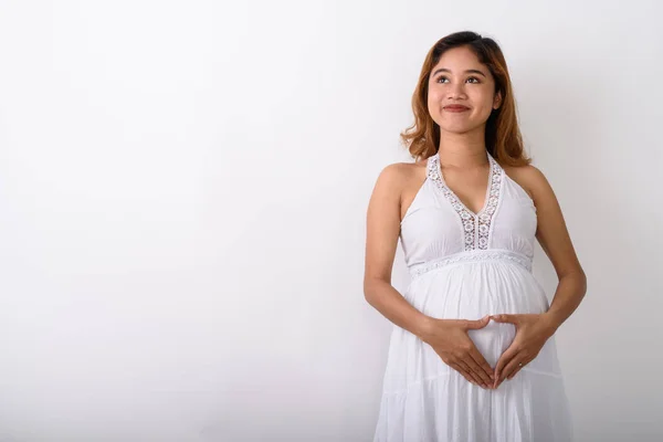 Studio shot de tineri asiatic gravidă femeie gândire în timp ce face — Fotografie, imagine de stoc