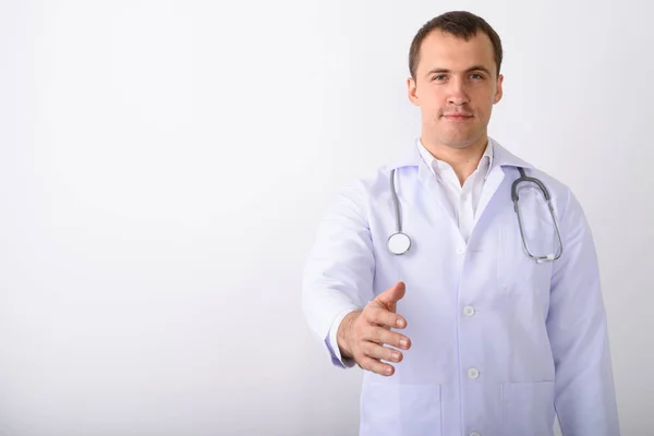 Estudio de tiro de joven musculoso médico hombre dando apretón de manos de nuevo — Foto de Stock