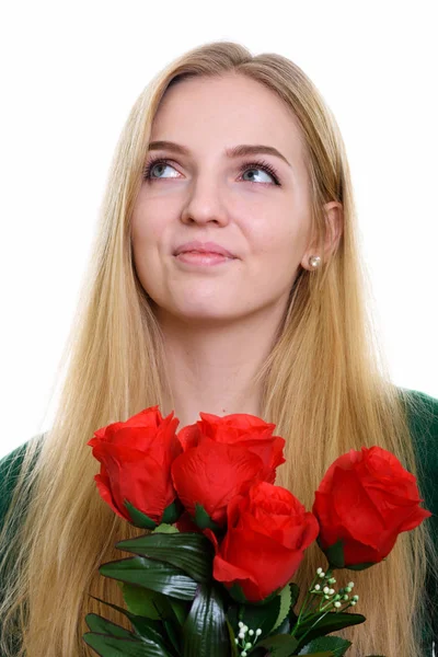 Twarz zadumany nastolatkę, trzymając czerwone róże gotowy do Vale — Zdjęcie stockowe
