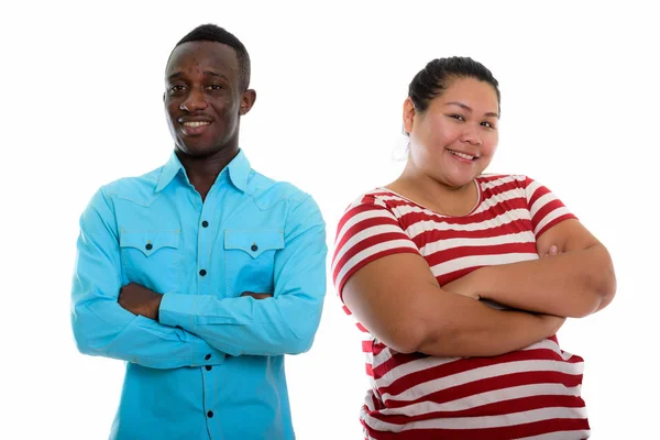 Young happy mixed race couple smiling with arms crossed — Stock Photo, Image