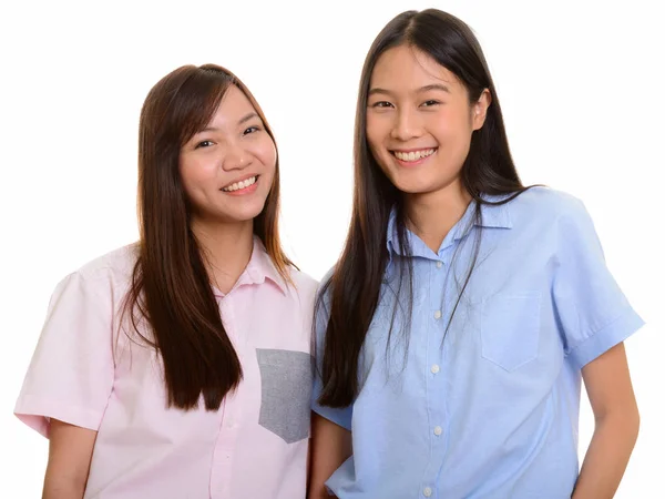 Two young happy Asian teenage girls smiling — Stock Photo, Image