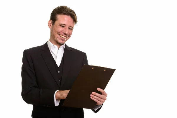 Happy Caucasian businessman reading good news from clipboard — Stock Photo, Image