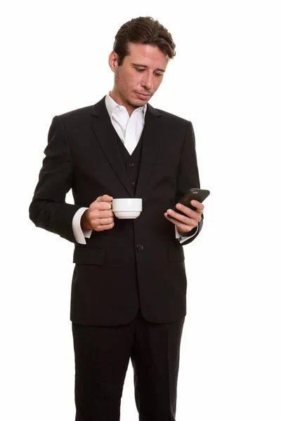 Handsome Caucasian businessman using mobile phone while holding — Stock Photo, Image
