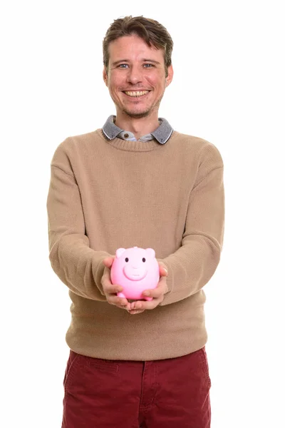 Piggy bank holding, miközben mosolyogva kaukázusi, boldog. — Stock Fotó
