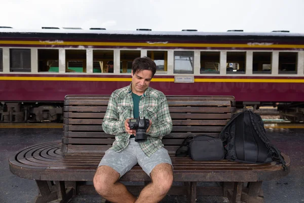 Handsome Persian tourist man at the railway station in Bangkok, — Stock Photo, Image