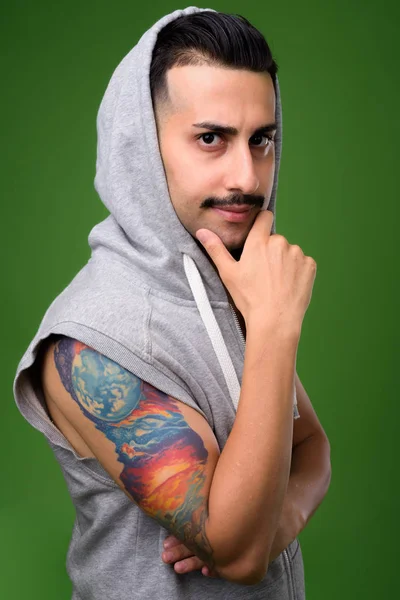 Красивий Іранський юнак з вусами проти зелений backgroun — стокове фото