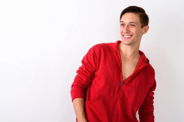 Studio shot of happy young handsome man smiling while looking to — Stock Photo, Image