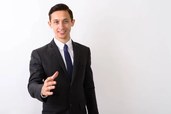 Studio shot de jeune homme d'affaires heureux souriant tout en donnant la main — Photo