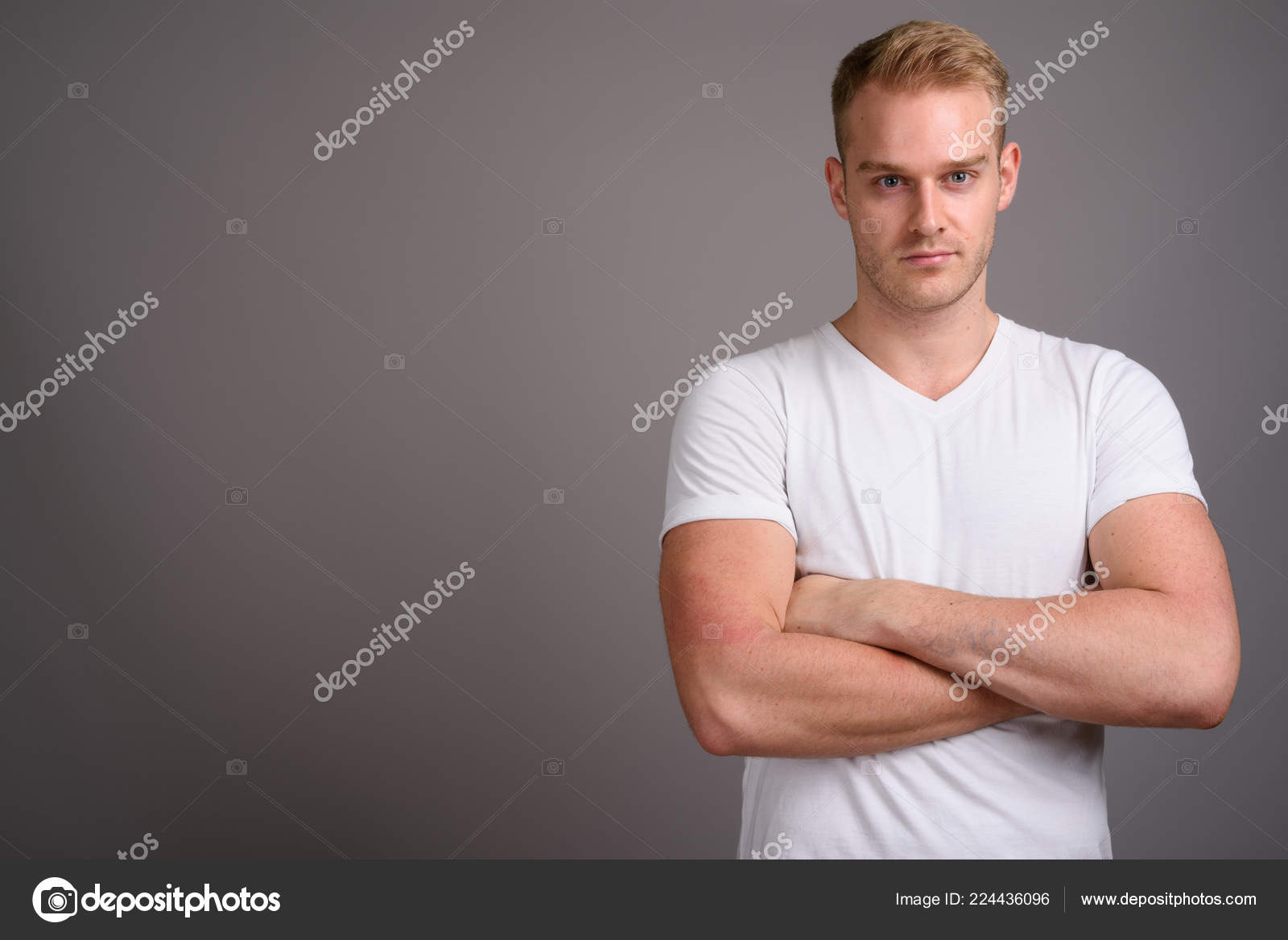Young Handsome Man With Blond Hair Against Gray Background Stock