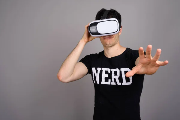 Jovem bonito nerd homem vestindo virtual realidade fone de ouvido — Fotografia de Stock