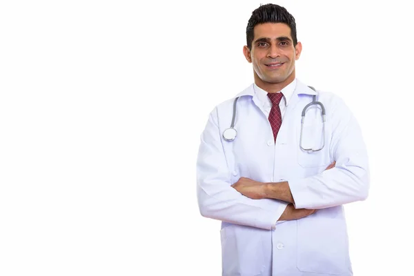 Studio shot of young happy Persian man doctor smiling with arms — Stock Photo, Image