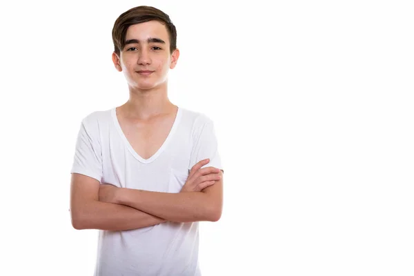 Studio shot of young handsome Persian teenage boy with arms cros — Stock Photo, Image