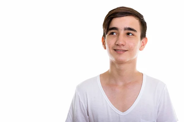 Studio shot of young happy Persian teenage boy smiling and think — Stock Photo, Image