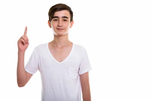 Studio shot of young handsome Persian teenage boy pointing finge — Stock Photo, Image