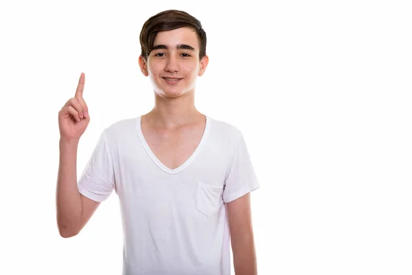 Studio shot of young happy persan adolescent garçon sourire tandis que poi — Photo