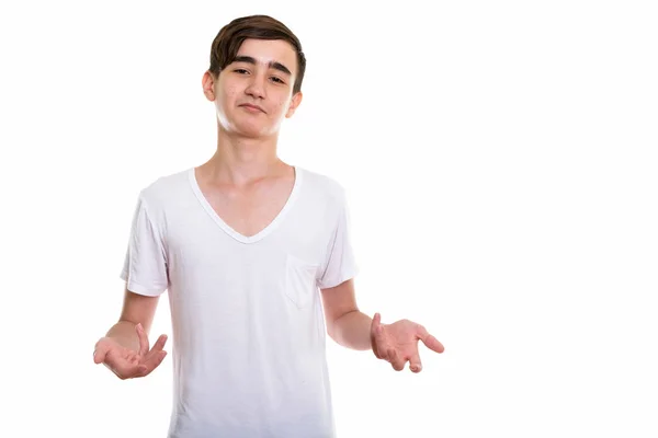 Studioaufnahme eines jungen hübschen persischen Teenagers, der verwirrt aussieht — Stockfoto