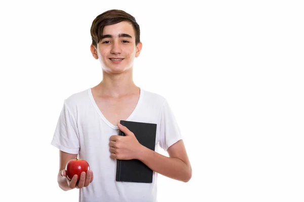 Studio shot van gelukkig Perzisch tiener jongen glimlachen terwijl hol — Stockfoto