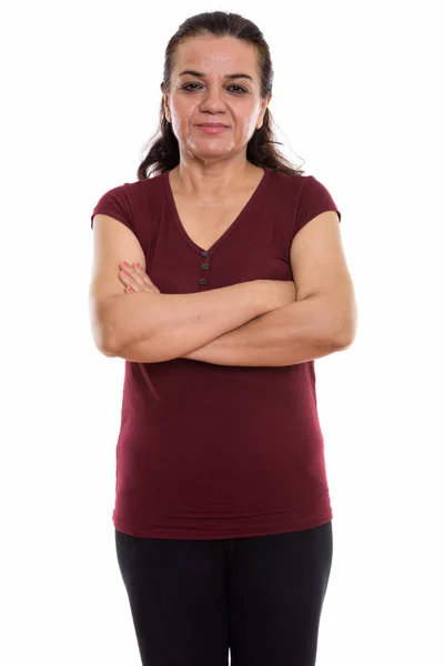 Studio shot of mature Persian woman standing with arms crossed — Stock Photo, Image