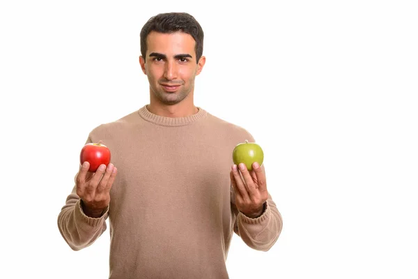 Hombre persa guapo sosteniendo saludable manzana verde y roja — Foto de Stock