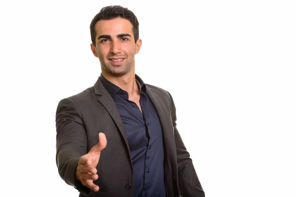 Porträtt av ung snygg persisk affärsman ger handslag — Stockfoto