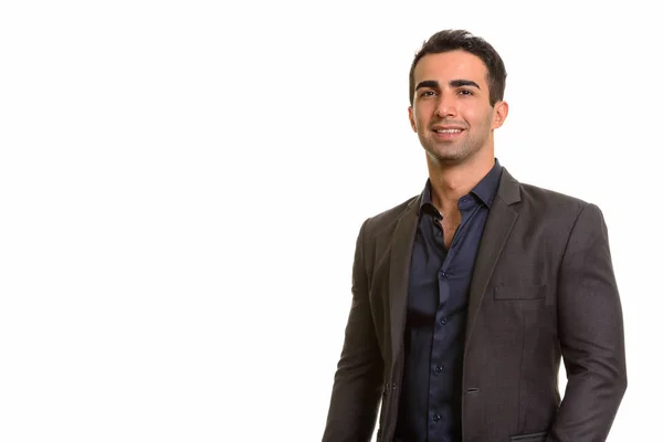 Porträt eines jungen glücklichen persischen Geschäftsmannes vor weißem Hintergrund — Stockfoto