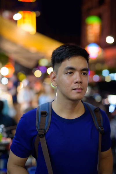 Young Asian tourist man exploring at Chinatown in Bangkok Thailand