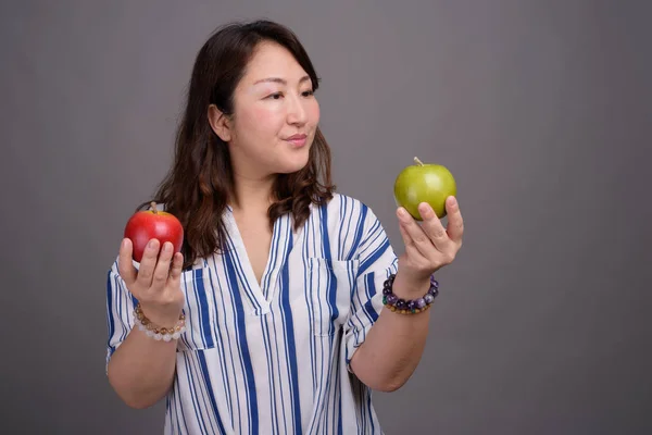 Madura hermosa mujer de negocios asiática sosteniendo manzana saludable — Foto de Stock