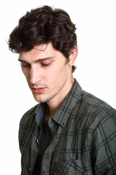 Face of young handsome man thinking while looking down — Stock Photo, Image