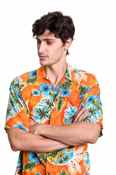 Studio shot of young handsome man thinking with arms crossed — Stock Photo, Image