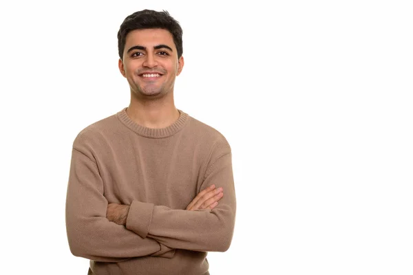 Joven hombre persa feliz sonriendo con los brazos cruzados —  Fotos de Stock