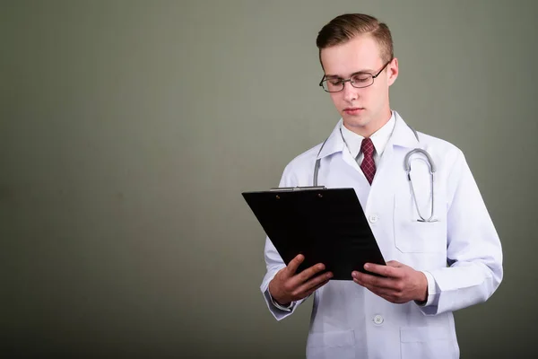 Jeune beau médecin homme sur fond de couleur — Photo