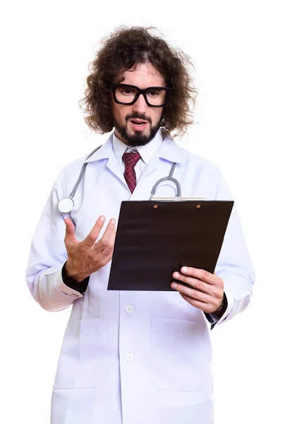 Studio shot of angry man doctor reading on clipboard — Stock Photo, Image