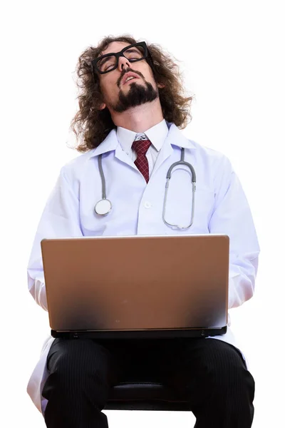 Studio shot of tired man doctor sleeping with laptop — Stock Photo, Image