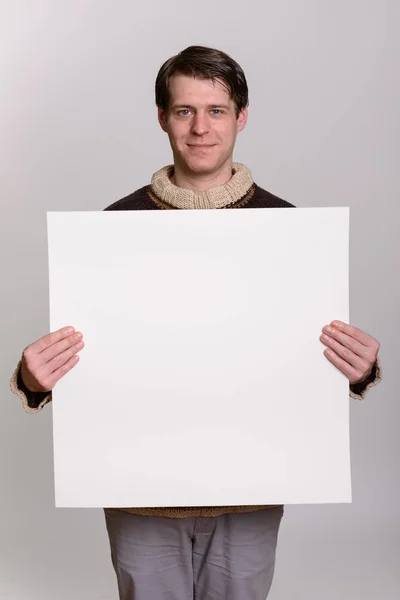 Handsome Caucasian Man Holding Copyspace Gray Background — Stock Photo, Image