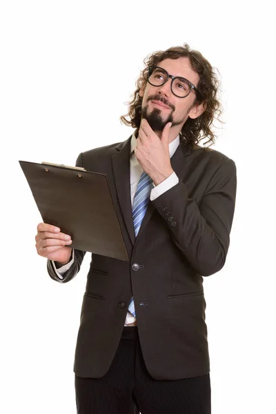 Guapo caucásico hombre de negocios leyendo portapapeles mientras piensa —  Fotos de Stock