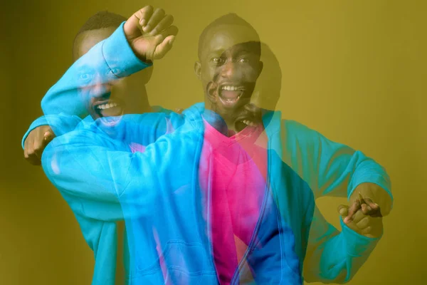 Double exposure shot of young African man against green background — Stock Photo, Image