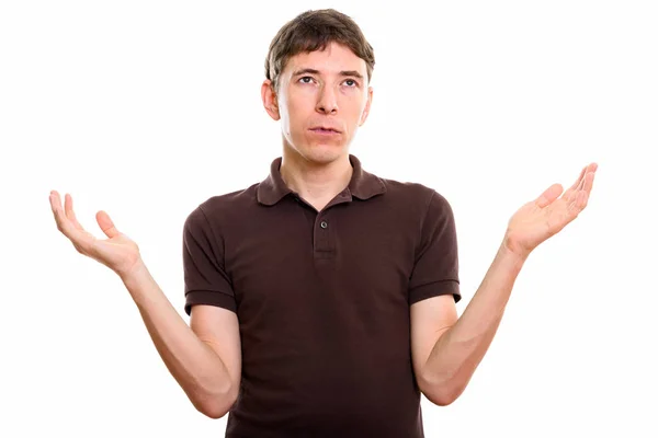 Studio shot of man looking confused with both arms raised — Stock Photo, Image