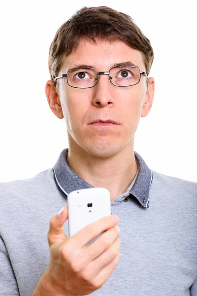 Face of man holding mobile phone while thinking — Stock Photo, Image