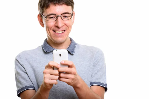 Close up of happy man smiling while using mobile phone — Stock Photo, Image
