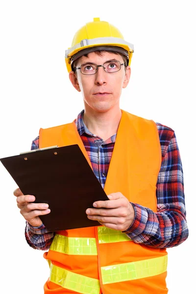 Studio shot of man construction worker holding clipboard while t — Stock Photo, Image