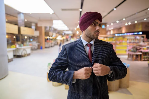 Portrait of Indian businessman with turban in shopping mall
