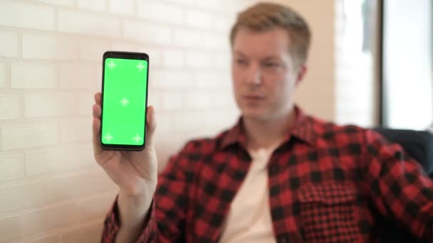 Junger glücklicher Hipster-Mann zeigt Handy und gibt Daumen hoch — Stockvideo