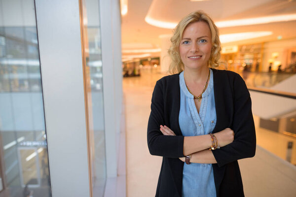 Portrait of beautiful blonde businesswoman inside shopping mall