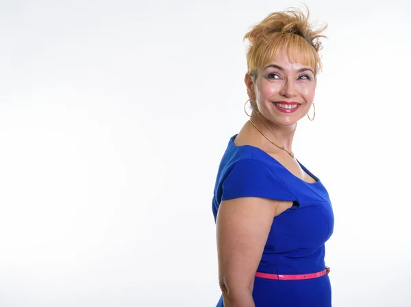 Studio shot of happy senior Asian woman smiling while thinking a — Stock Photo, Image