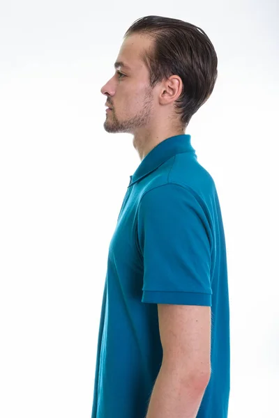 Profile view portrait of young bearded man against white background — Stock Photo, Image