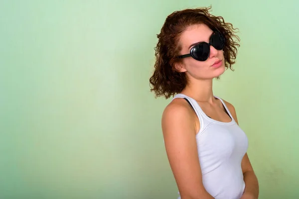 Studio shot of beautiful teenage girl wearing heart shaped sungl — Stock Photo, Image