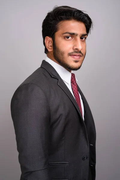 Portrait of Indian businessman against gray background — Stock Photo, Image